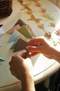 Grace Engel making origami garlands